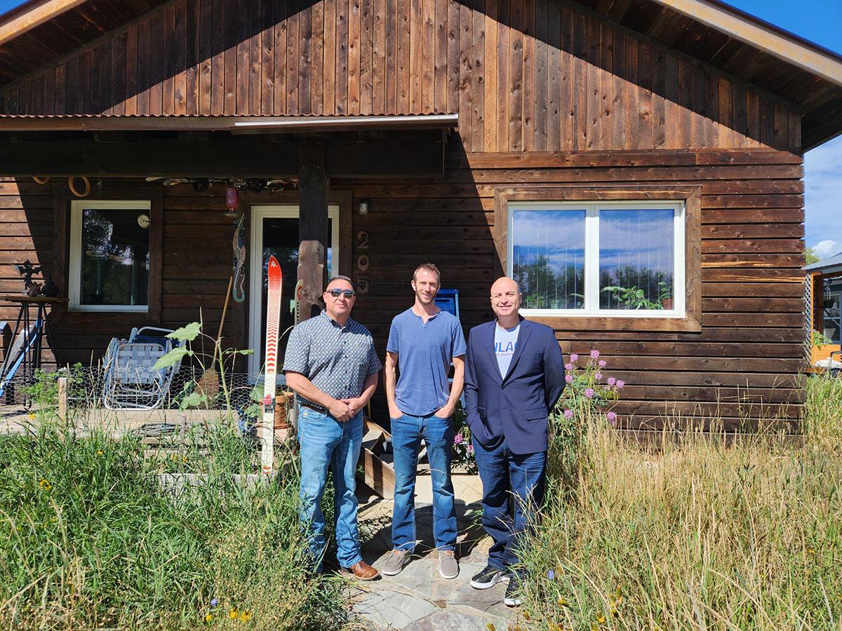 From left: NNMC Technical Trades Chair Joe Padilla, Architect Cillian Barrett and NNMC President Hector Balderas in front of a straw bale house built by Barrett for Habitat for Humanity. This is the type of construction the pilot boot camp students will work on under the supervision of Barrett and NNMC faculty.